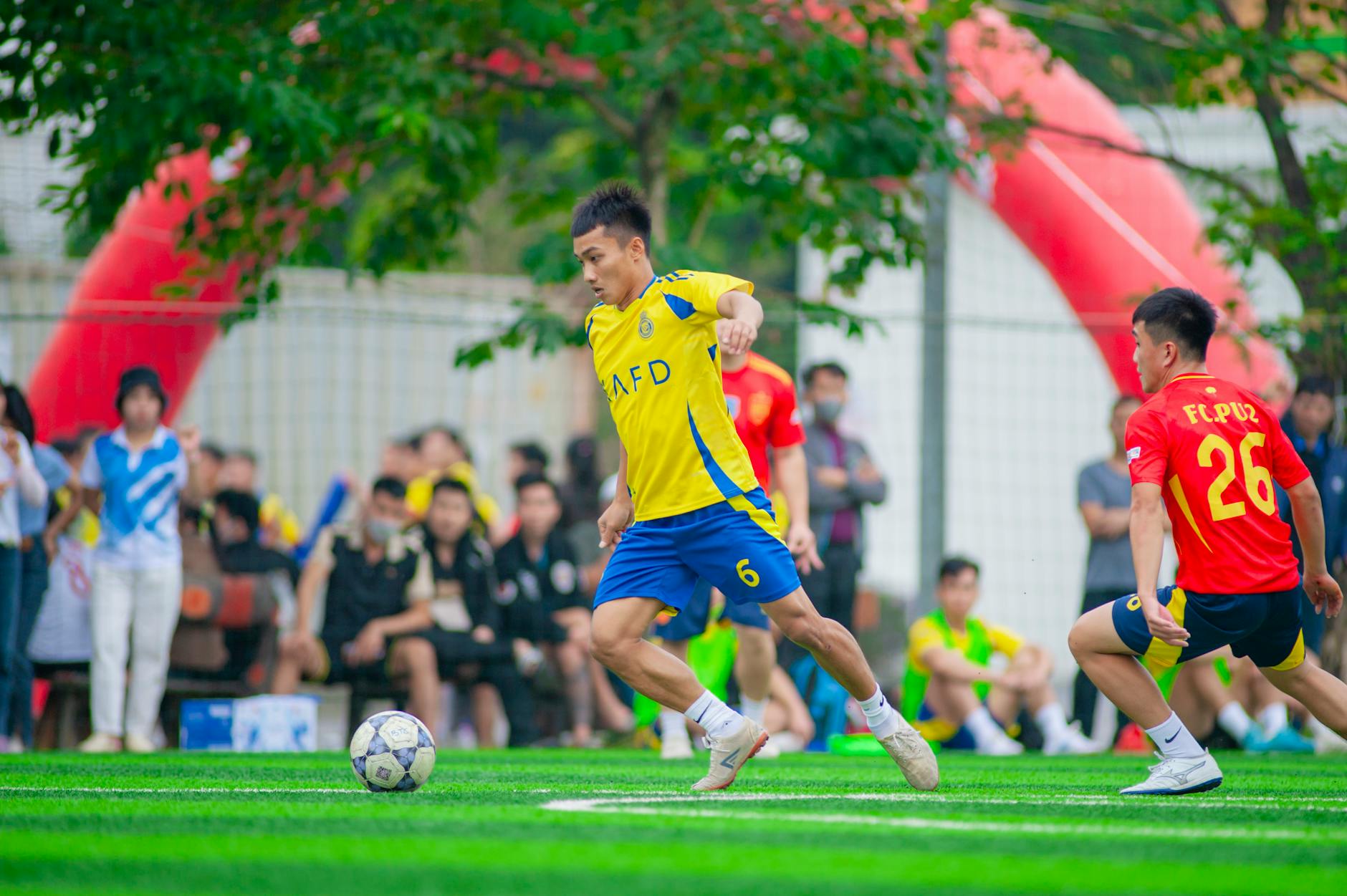Piłkarze w trakcie meczu na kolorowym boisku w Hanoi